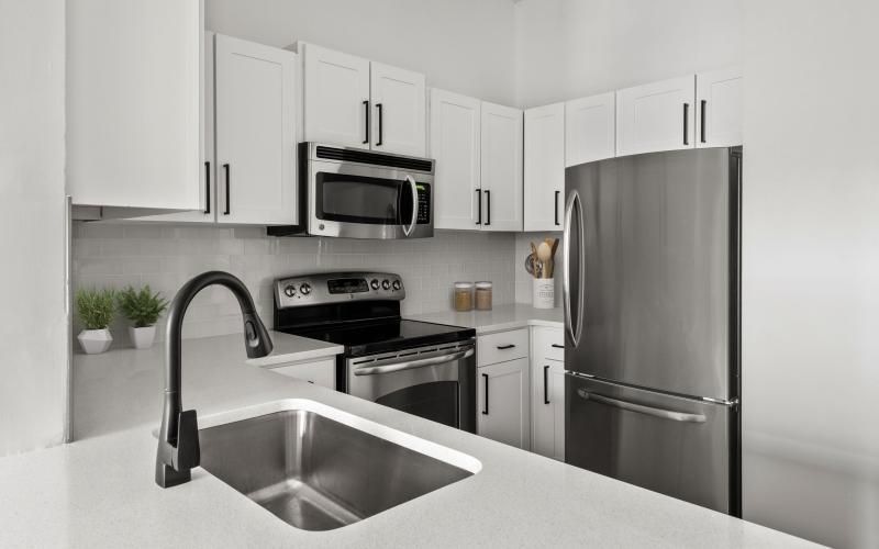 a kitchen with white cabinets