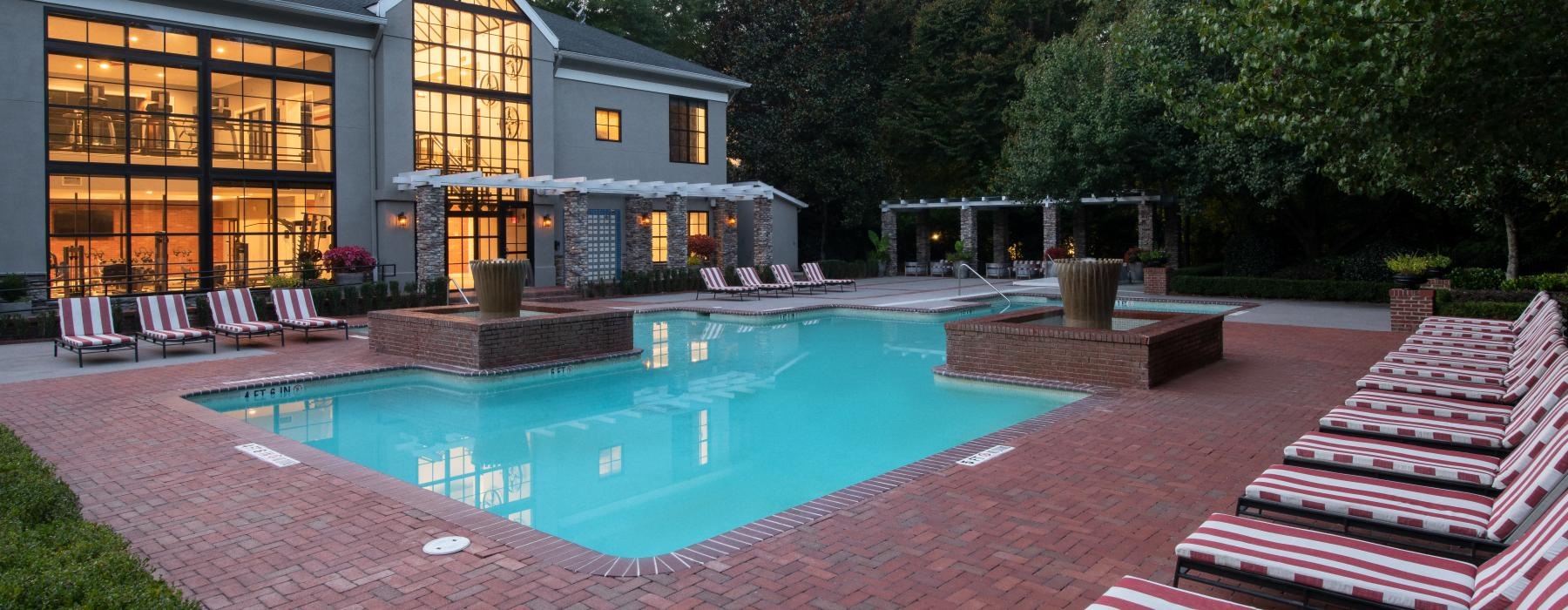 lounge chairs surround swimming pool