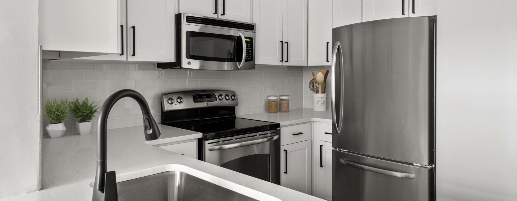 a kitchen with white cabinets