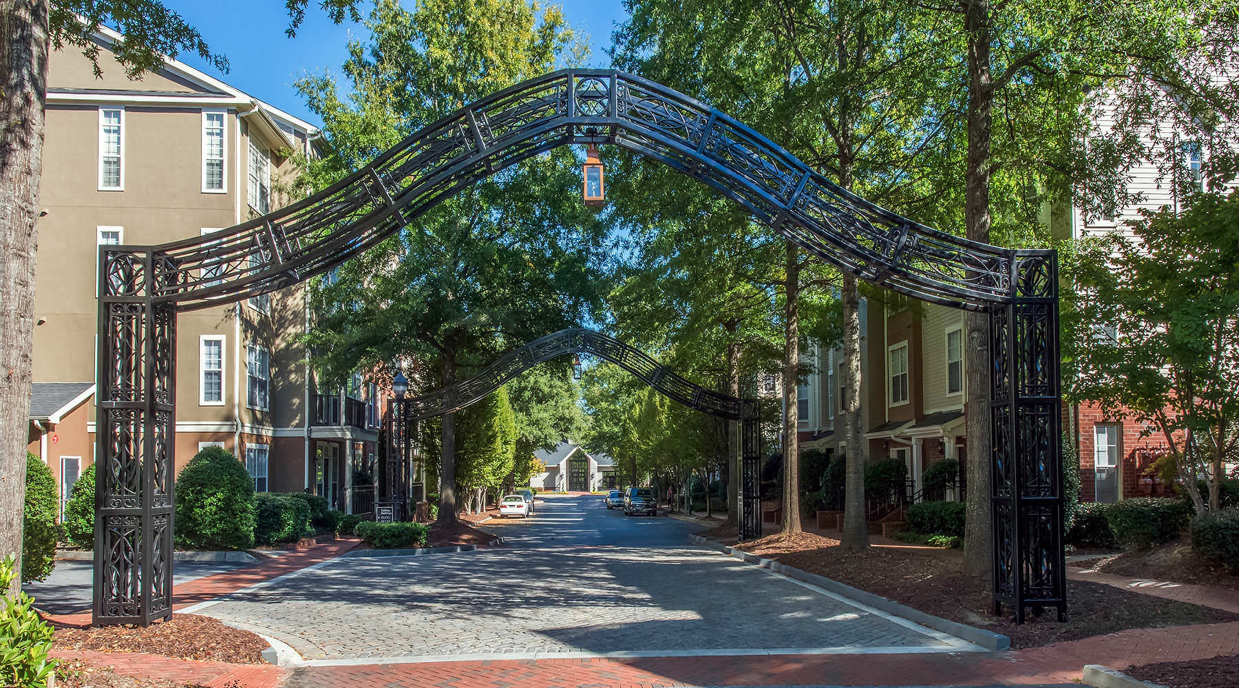 Where Luxury Meets Leisure metal archways over brick walking path